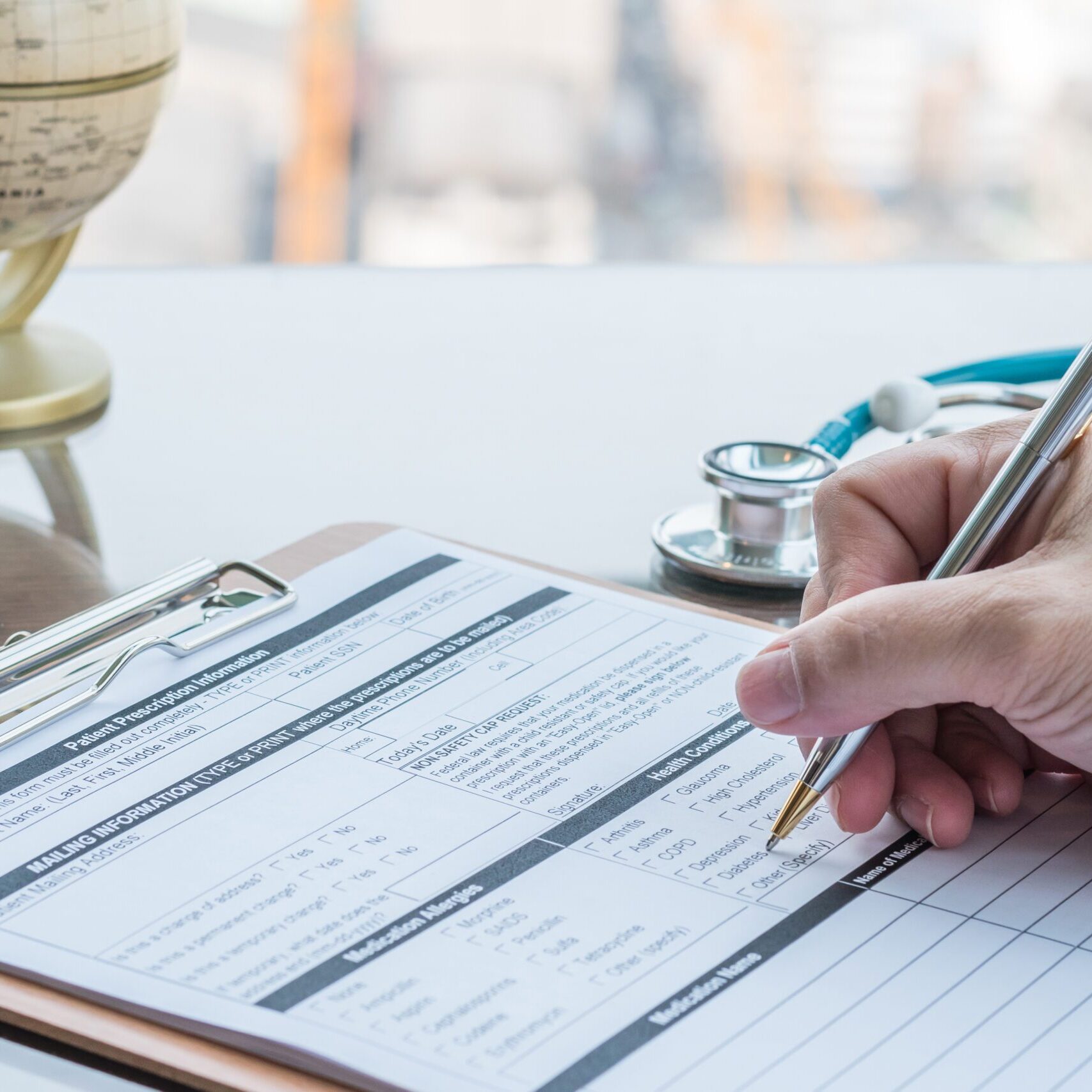 Doctor writing on medical health care record, patients discharge, or prescription form paperwork in hospital clinic